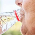 senior drinking water to hydrate