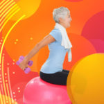 older woman balancing on a yoga blla