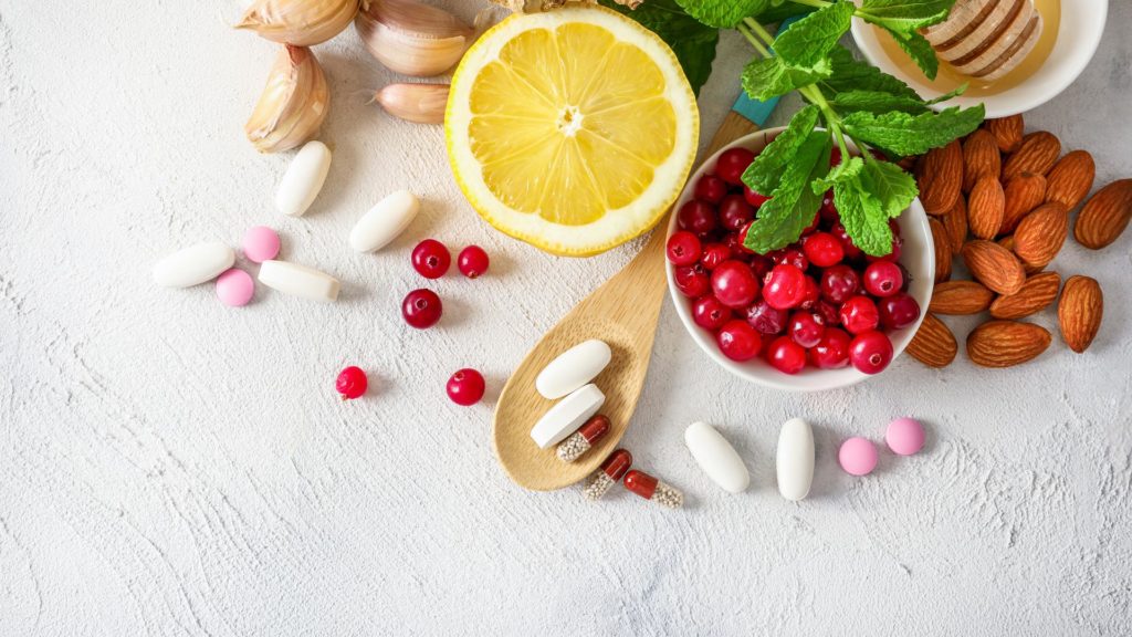 Food supplements on a table with fruit