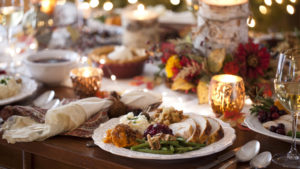 plate of food surrounded by table decor, wine and candles