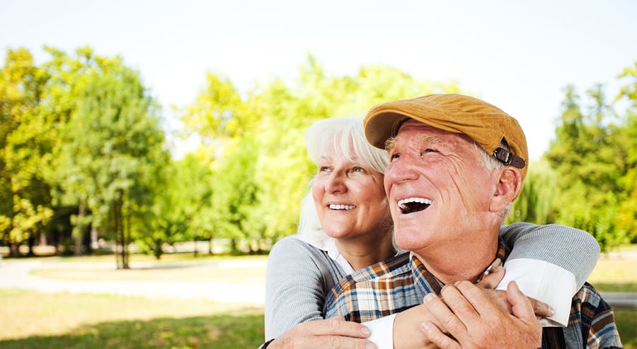 Aging couple smiling in park
